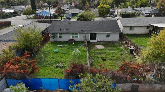 an aerial view of a house with a yard