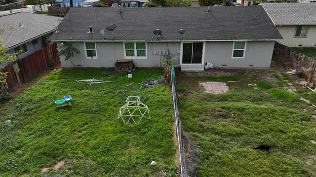 an aerial view of a house with yard