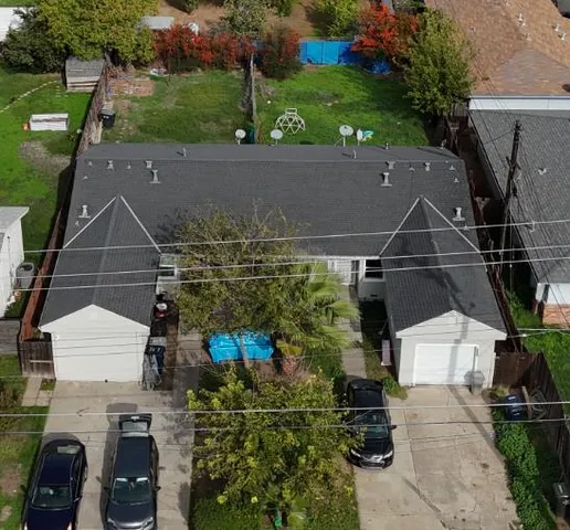 an aerial view of a house with a yard