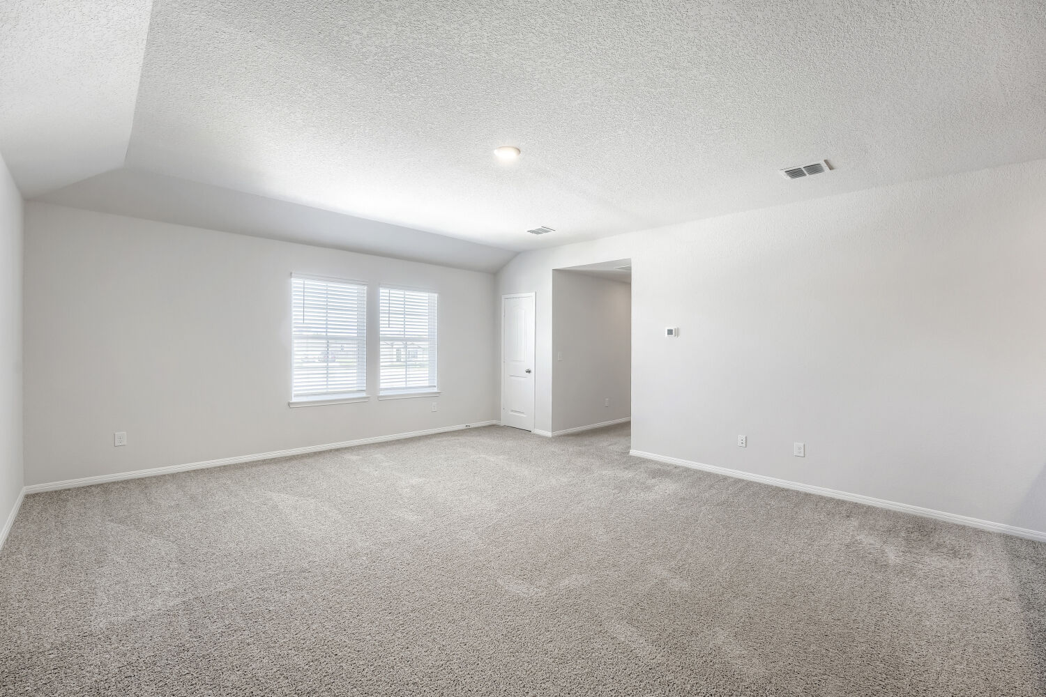 13507 Howser Trace Manor, TX 78653 - Photo 15 of 28 Sun-filled interior space with high vaulted ceilings and soft carpet welcomes any design aesthetic.
