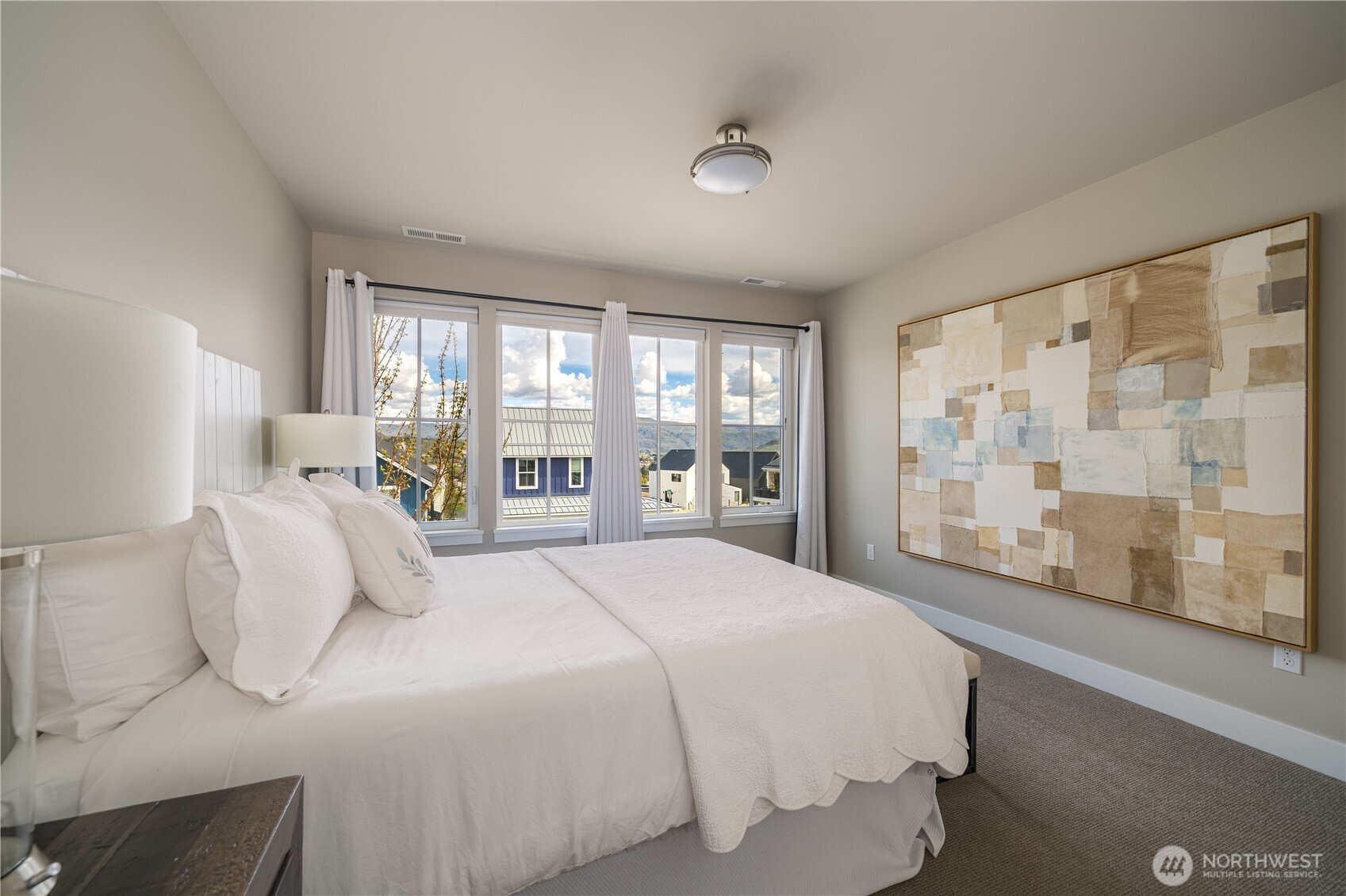 187 Bobcat Lane Chelan, WA 98816 - Photo 20 of 40 a bedroom with a large bed and a large window