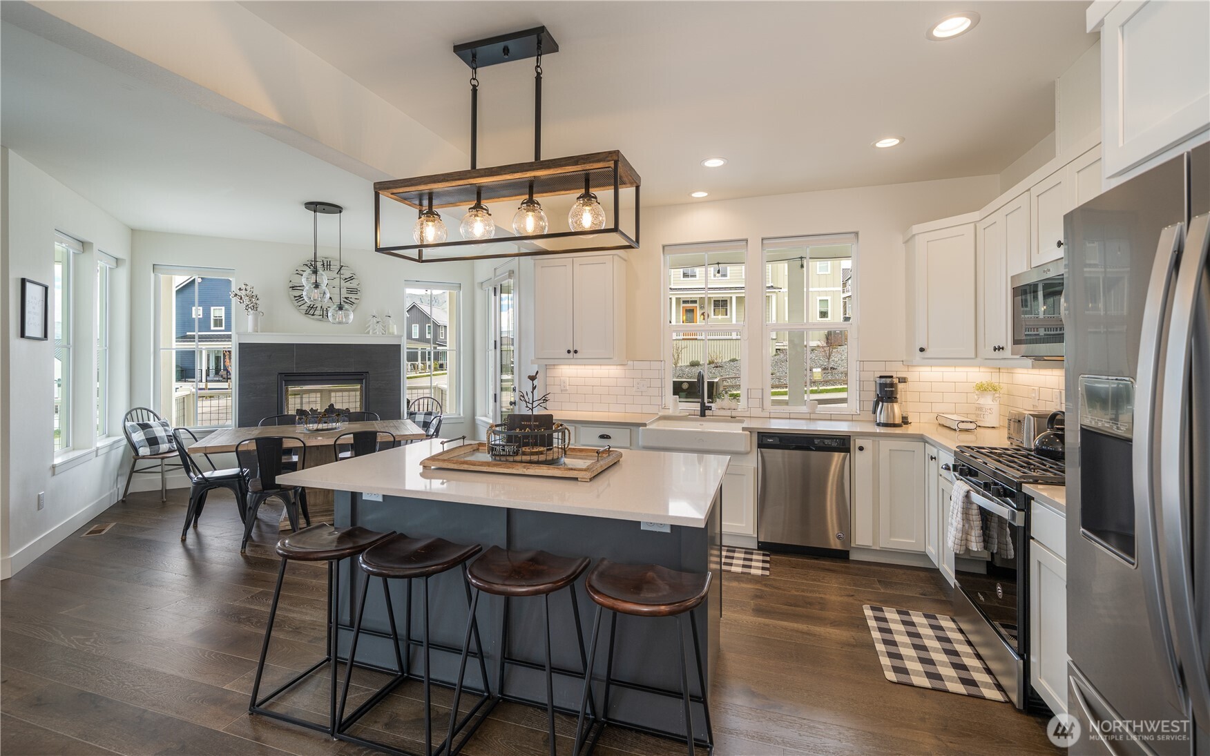 187 Bobcat Lane Chelan, WA 98816 - Photo 5 of 40 a kitchen with stainless steel appliances a dining table chairs stove refrigerator and microwave