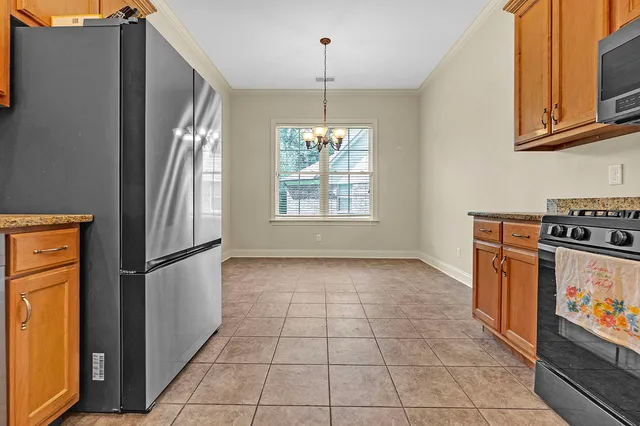 a kitchen with windows and refrigerator