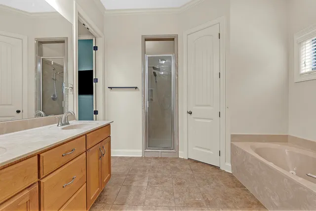 a bathroom with a tub sink and mirror