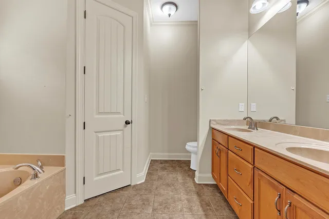 a spacious bathroom with a granite countertop sink and a mirror