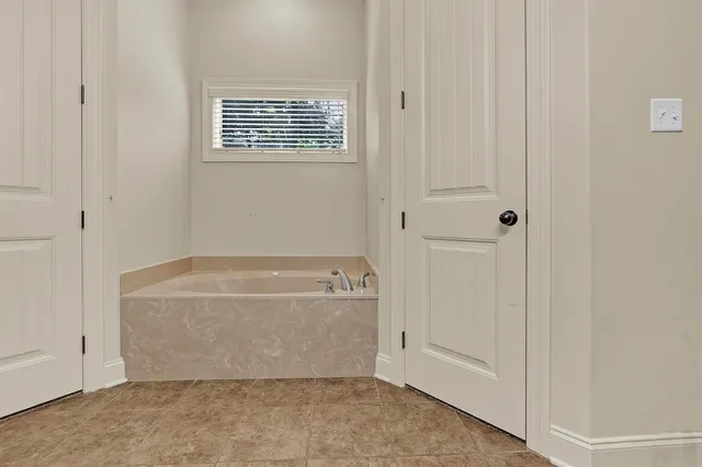a bathroom with bathtub window and shower