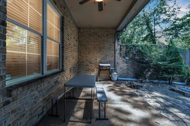 a backyard of a house with table and chairs