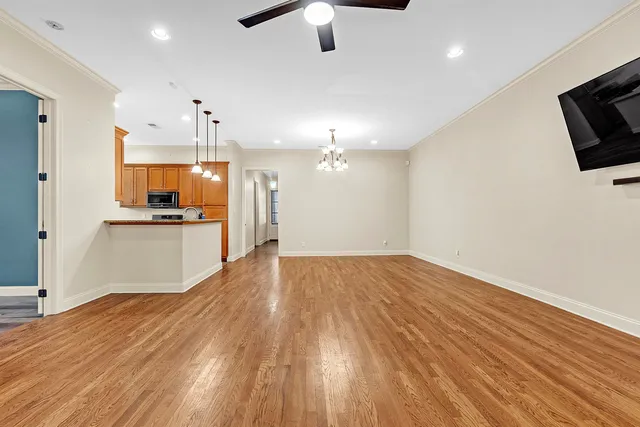 a view of a kitchen with a flat screen tv and refrigerator