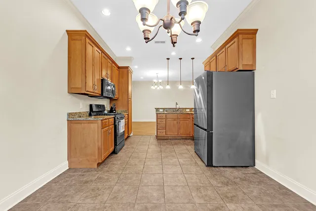 a kitchen with refrigerator and cabinets