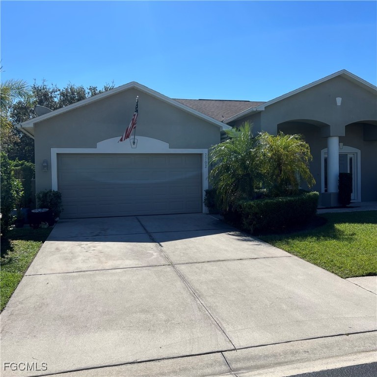 2702 Nature Pointe Loop Fort Myers, FL 33905 - Photo 2 of 25 a front view of a house with garden