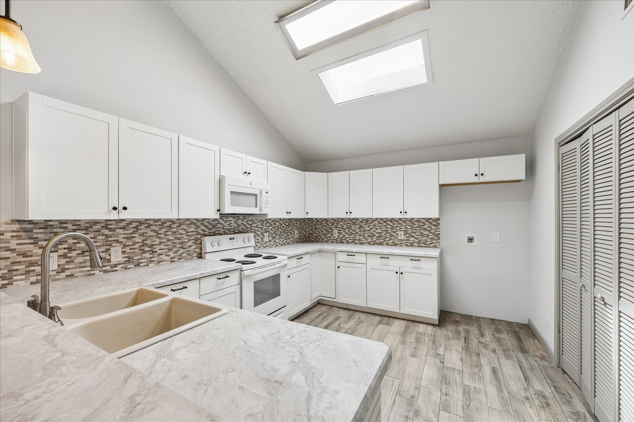 206 Lockett Street Brenham, TX 77833 - Photo 5 of 12 a kitchen with a sink stove and cabinets