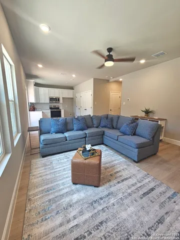 a living room with furniture and a chandelier