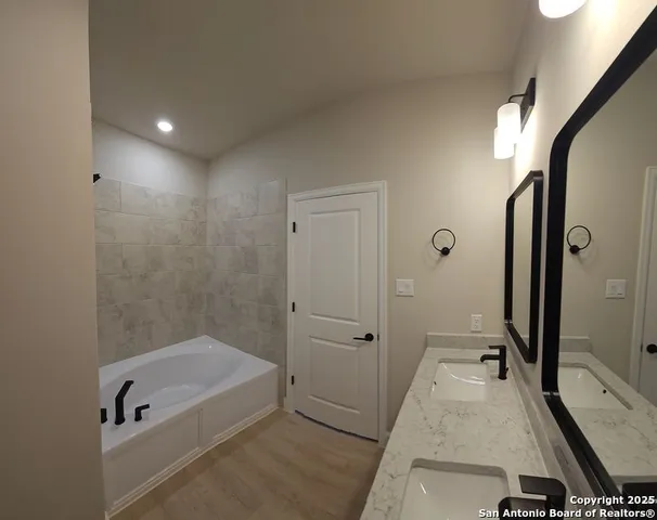 a bathroom with a tub and a shower