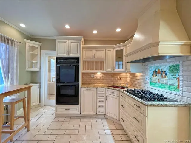a kitchen with stainless steel appliances granite countertop a stove and a refrigerator