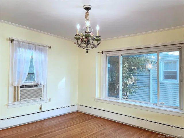 a view of a room with wooden floor and a window