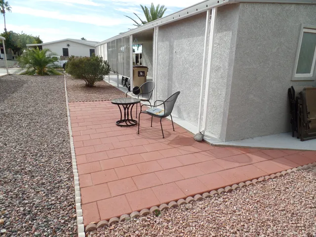 a view of a patio with table and chairs and potted plants
