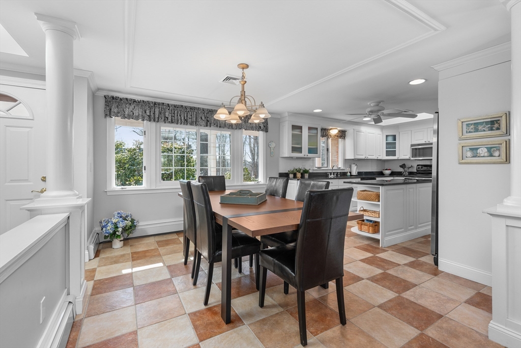 91 Holly Point Road Barnstable, MA 02632 - Photo 12 of 42 a dining room filled kitchen with a table and chairs in it