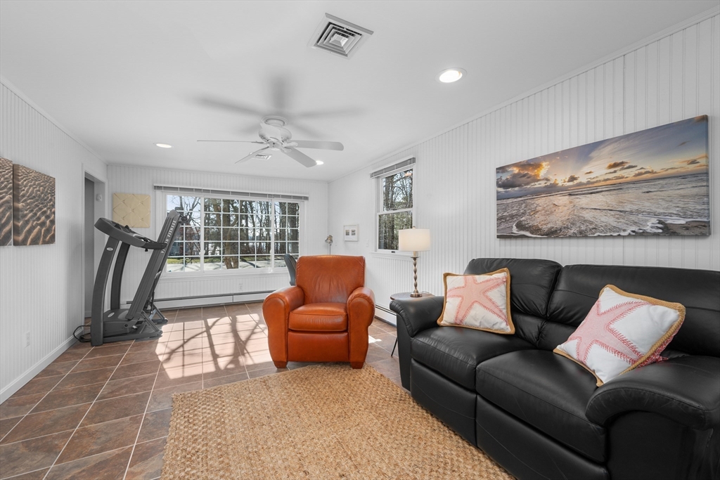 91 Holly Point Road Barnstable, MA 02632 - Photo 14 of 42 a living room with furniture a ceiling fan and a rug