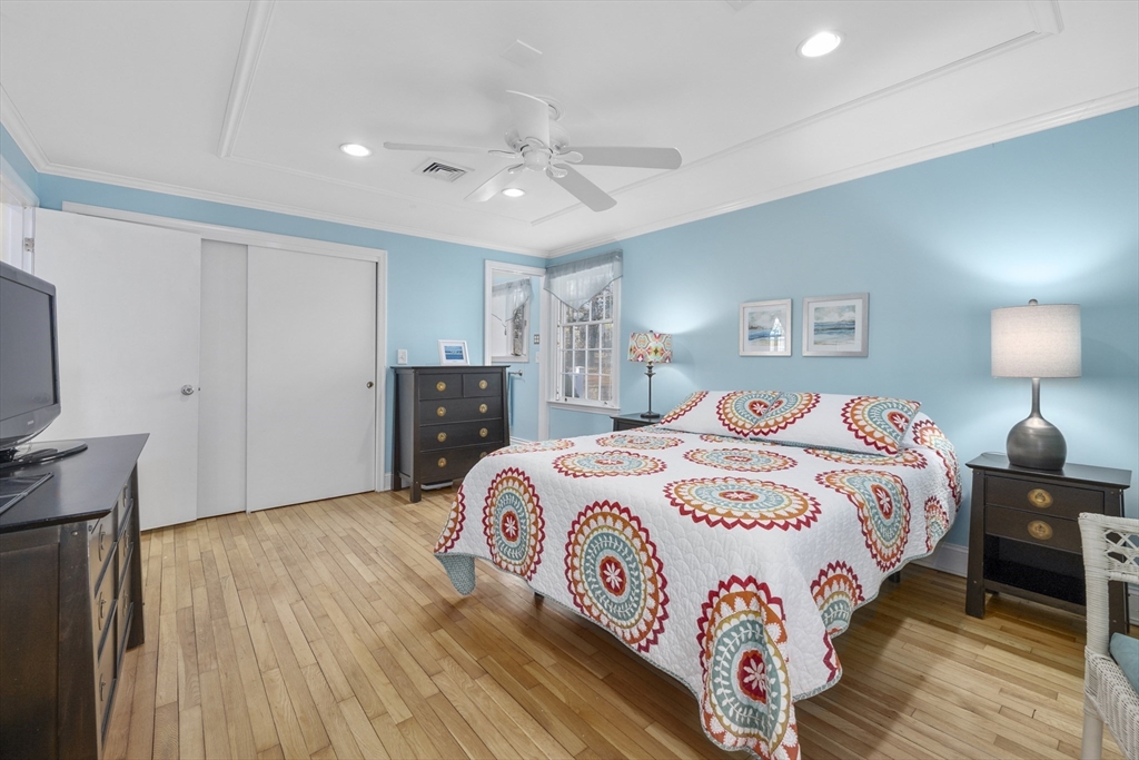 91 Holly Point Road Barnstable, MA 02632 - Photo 20 of 42 a bedroom with a large bed and a flat tv screen on dresser