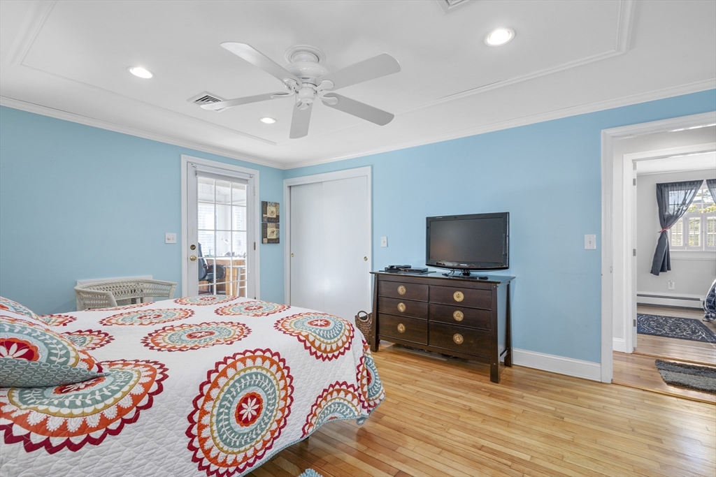 91 Holly Point Road Barnstable, MA 02632 - Photo 21 of 42 a bedroom with a bed and a flat screen tv