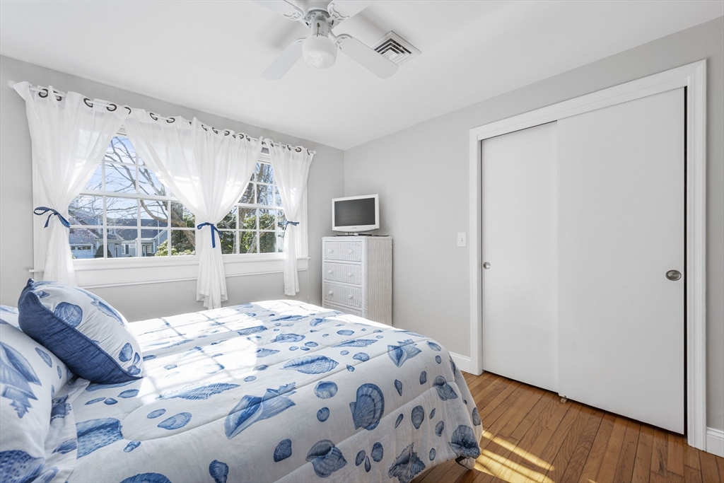 91 Holly Point Road Barnstable, MA 02632 - Photo 24 of 42 a bedroom with a large bed and a window