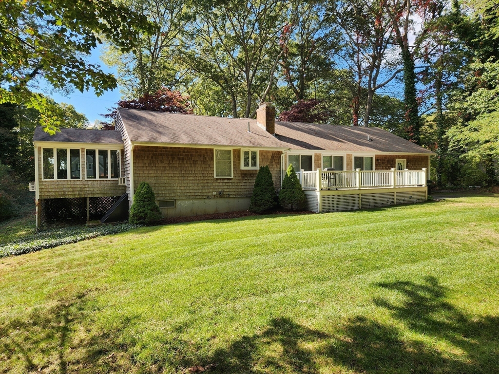91 Holly Point Road Barnstable, MA 02632 - Photo 30 of 42 a front view of a house with a garden