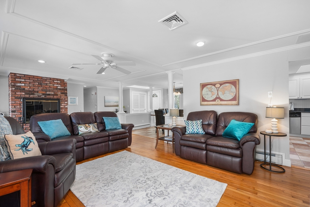 91 Holly Point Road Barnstable, MA 02632 - Photo 4 of 42 a living room with furniture and a fireplace