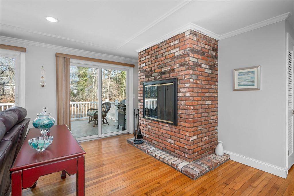 91 Holly Point Road Barnstable, MA 02632 - Photo 7 of 42 a living room with furniture a flat screen tv and a fireplace