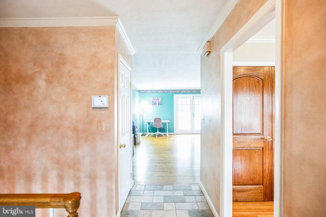 a view of a hallway with wooden floor and closet