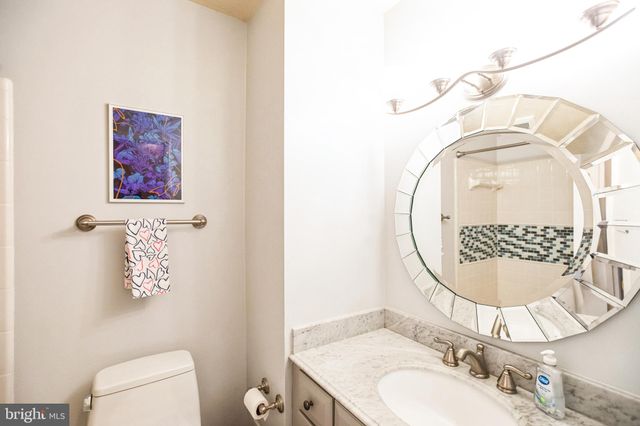 a bathroom with a sink mirror and toilet