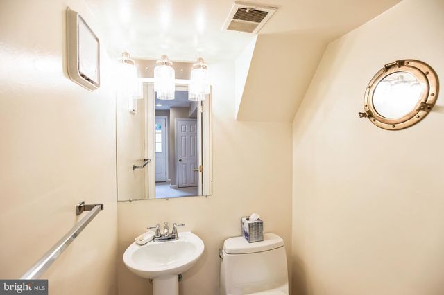 a bathroom with a sink a mirror and a toilet