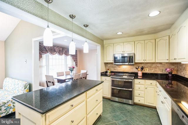 a kitchen with stainless steel appliances granite countertop a stove and a sink