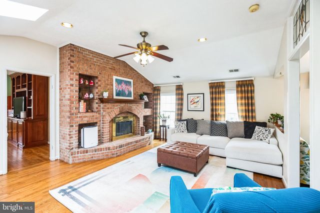 a living room with fireplace furniture and a wooden floor