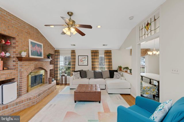 a living room with furniture a fireplace and a chandelier