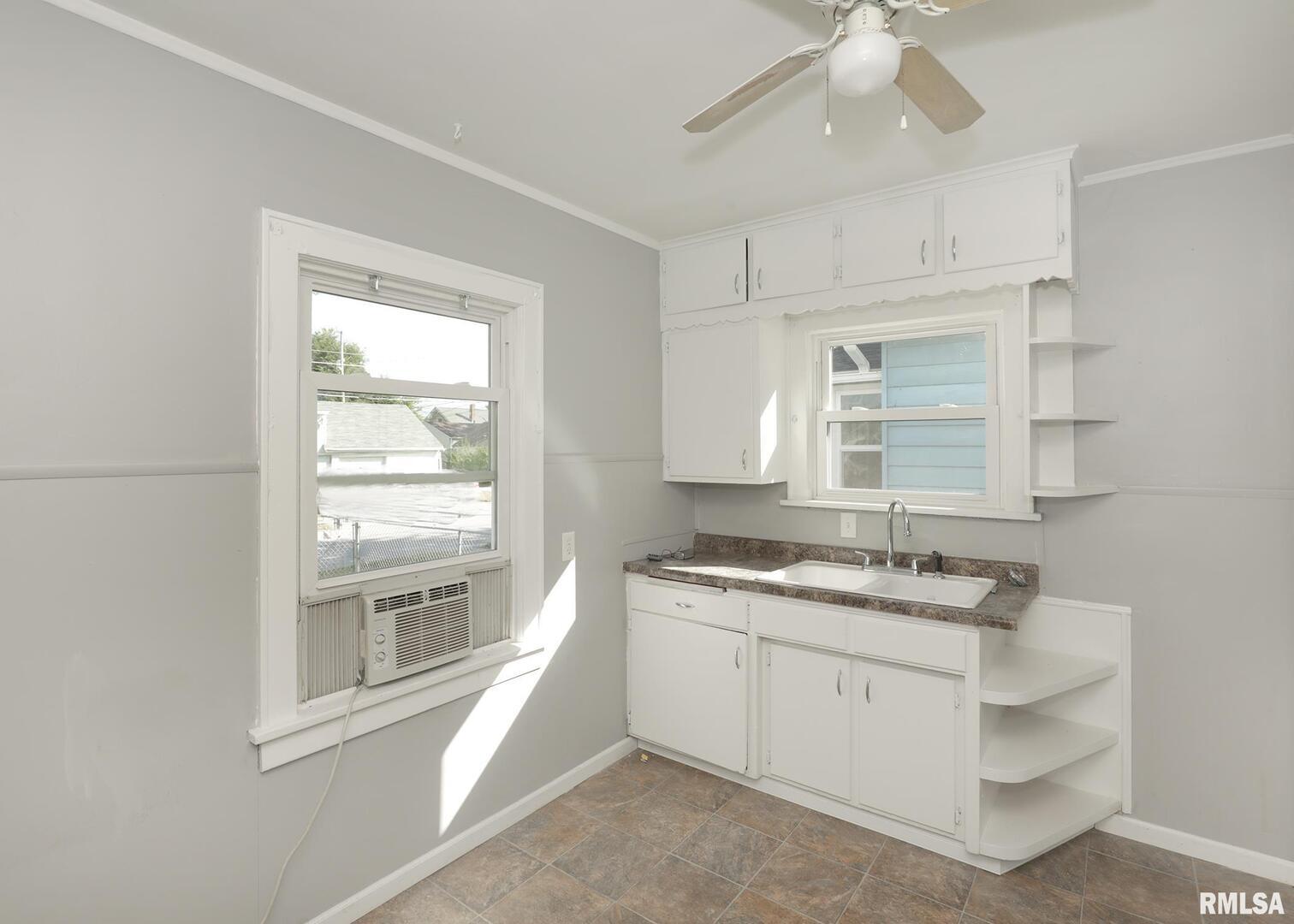 934 20th Avenue Rock Island, IL 61201 - Photo 11 of 26 a kitchen with a sink stove and cabinets