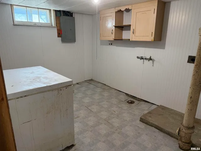 a utility room with cabinets washer and dryer