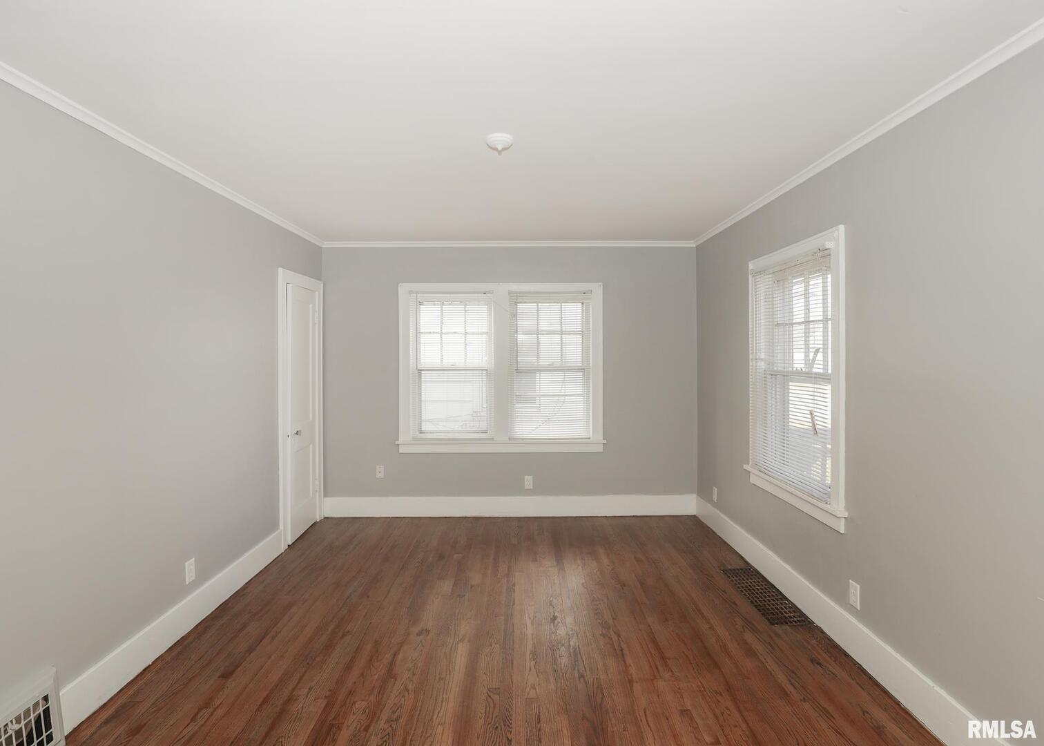 934 20th Avenue Rock Island, IL 61201 - Photo 6 of 26 an empty room with wooden floor and windows