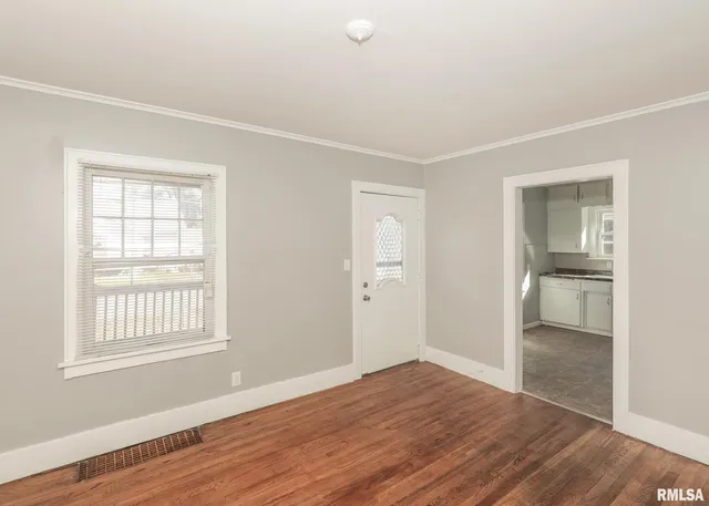 a view of wooden floor and windows in a room