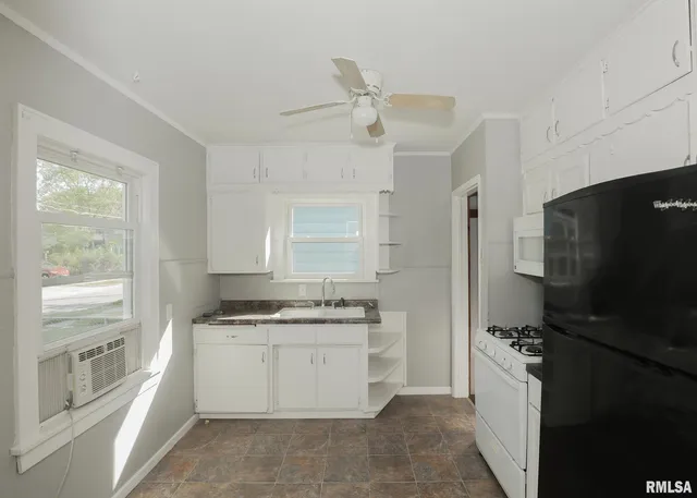a kitchen with a refrigerator stove and sink