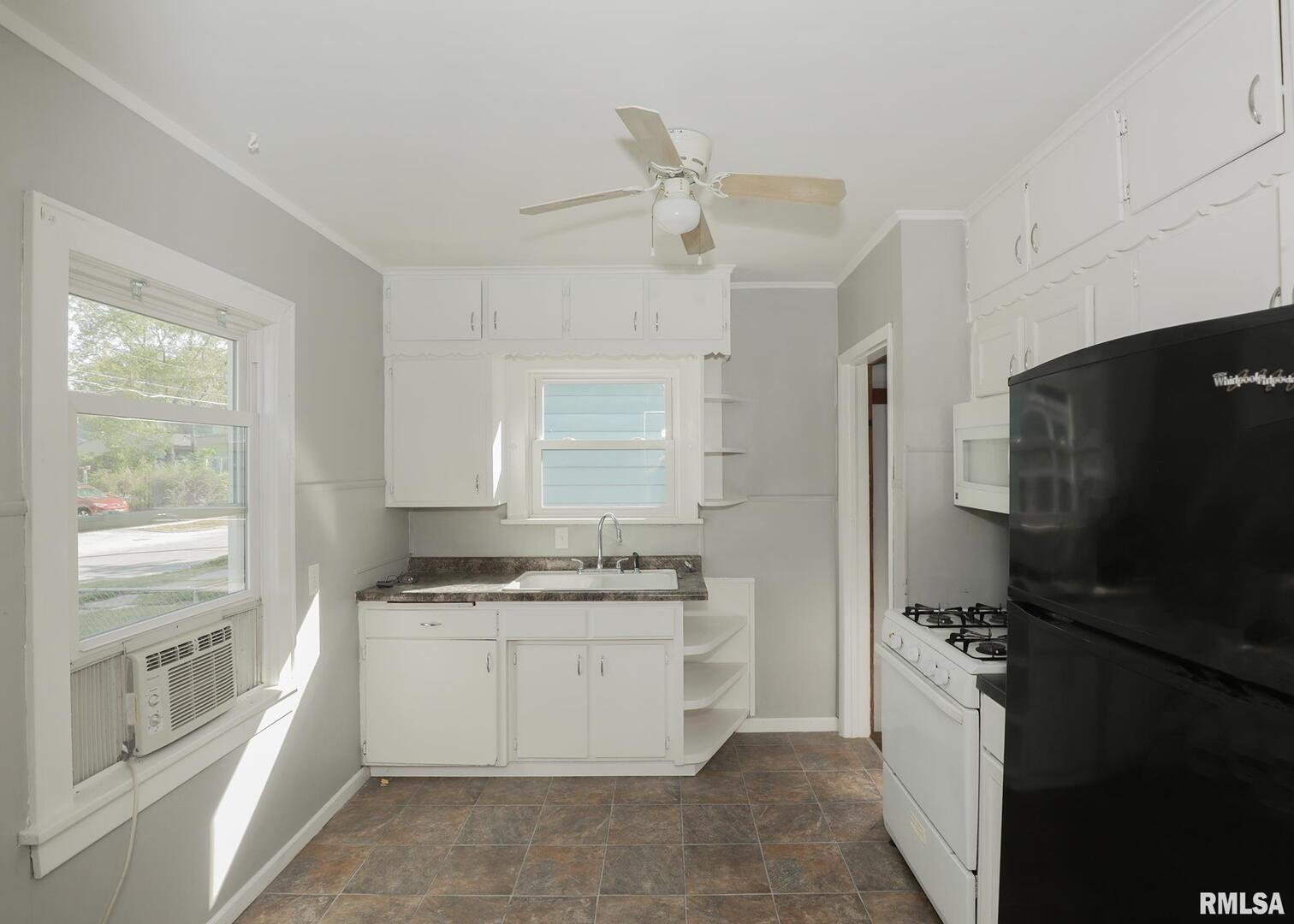 934 20th Avenue Rock Island, IL 61201 - Photo 8 of 26 a kitchen with a refrigerator stove and sink