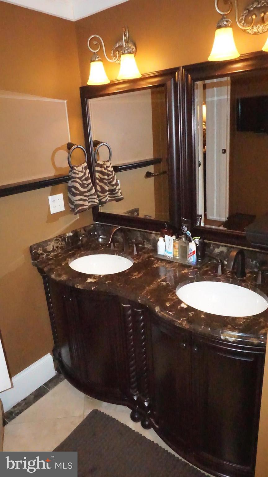 9105 Cuckold Point Road Baltimore, MD 21219 - Photo 102 of 150 a bathroom with a sink and a mirror