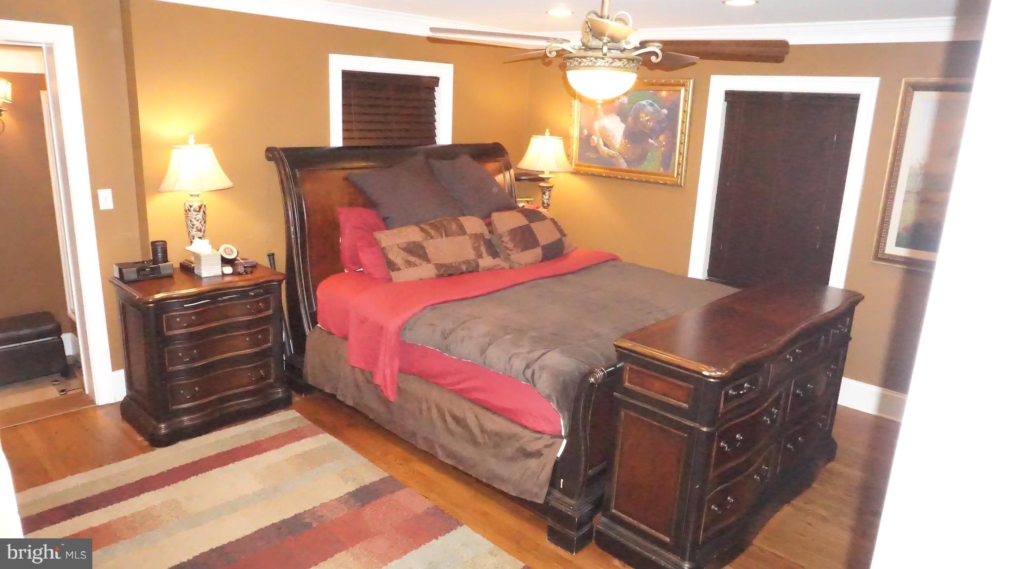 9105 Cuckold Point Road Baltimore, MD 21219 - Photo 105 of 150 a bedroom with a bed dresser and a window