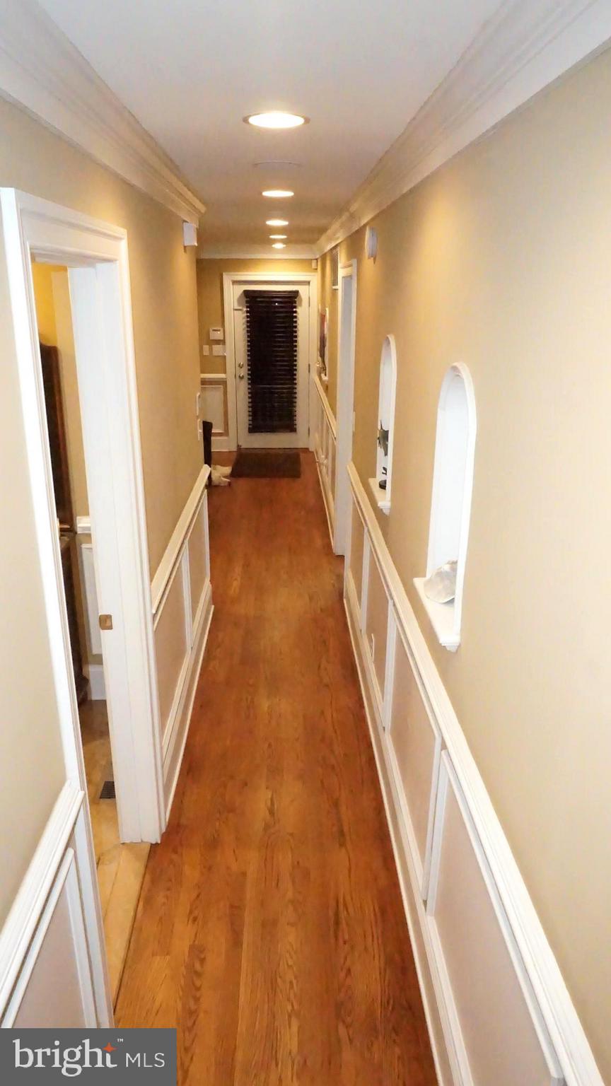9105 Cuckold Point Road Baltimore, MD 21219 - Photo 109 of 150 a view of a hallway with wooden floor and staircase