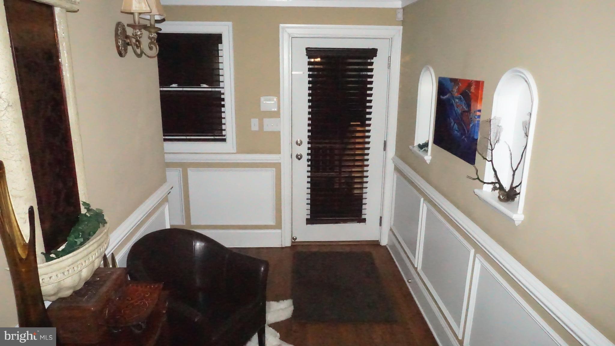 9105 Cuckold Point Road Baltimore, MD 21219 - Photo 110 of 150 a living room with furniture and a flat tv screen next to a window