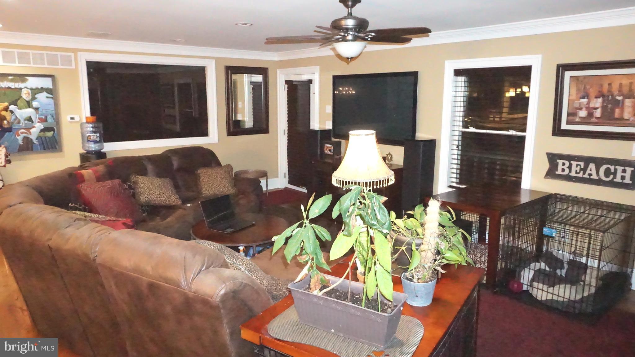 9105 Cuckold Point Road Baltimore, MD 21219 - Photo 119 of 150 a living room with furniture flowerpot and wooden floor