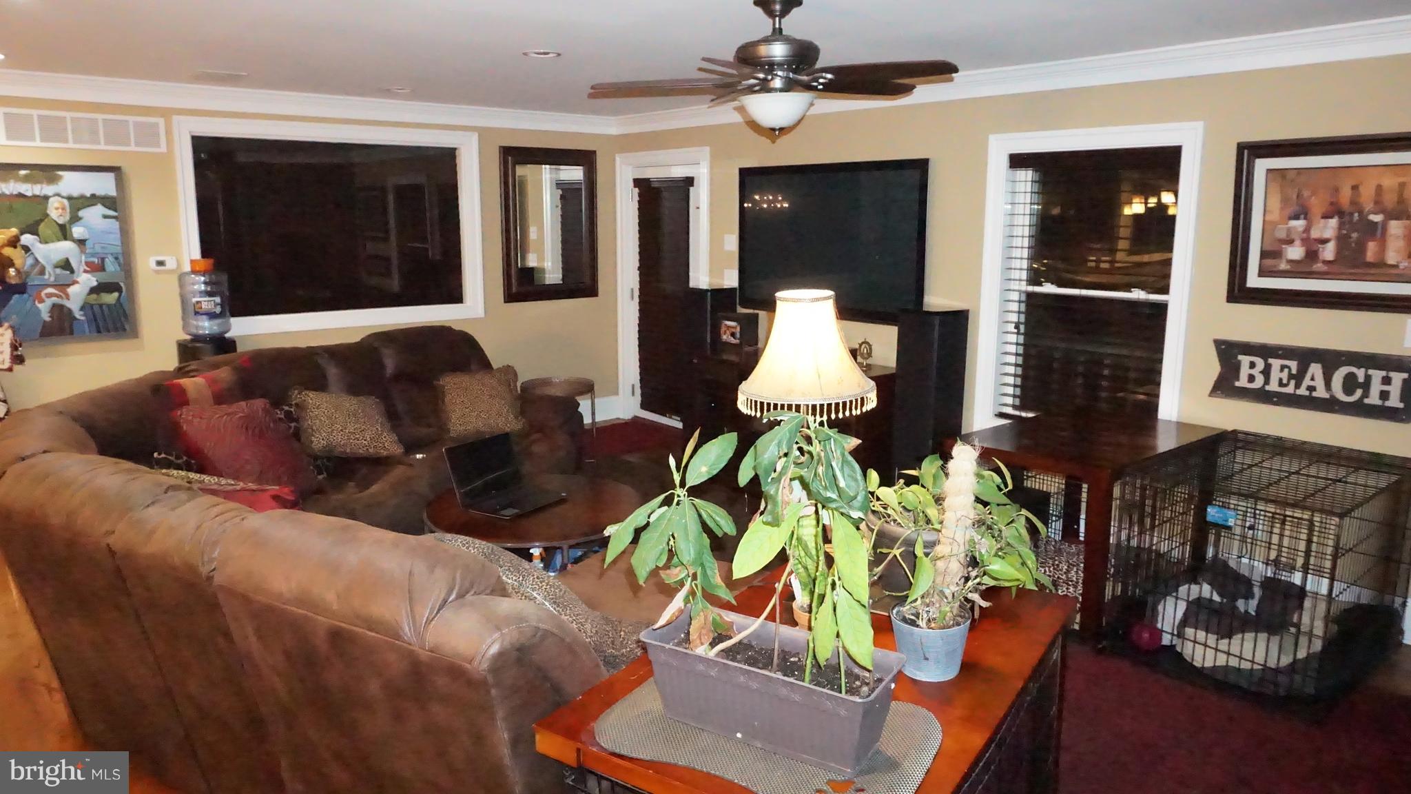 9105 Cuckold Point Road Baltimore, MD 21219 - Photo 133 of 150 a living room with furniture flowerpot and wooden floor