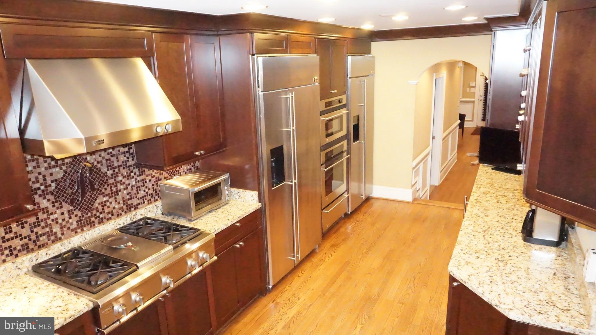 9105 Cuckold Point Road Baltimore, MD 21219 - Photo 141 of 150 a kitchen with stainless steel appliances granite countertop a refrigerator and a stove