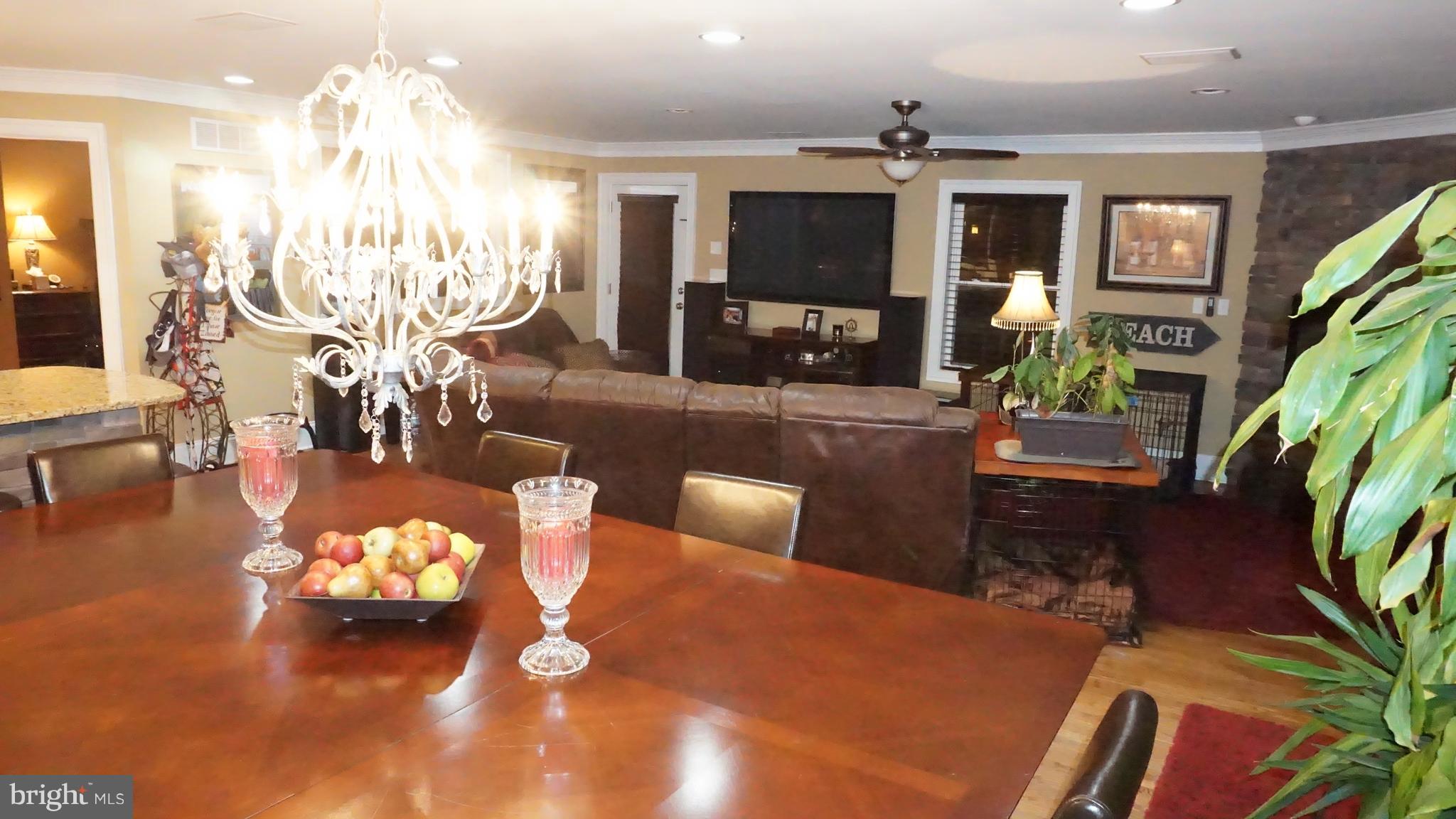 9105 Cuckold Point Road Baltimore, MD 21219 - Photo 17 of 150 a living room with patio furniture and a chandelier