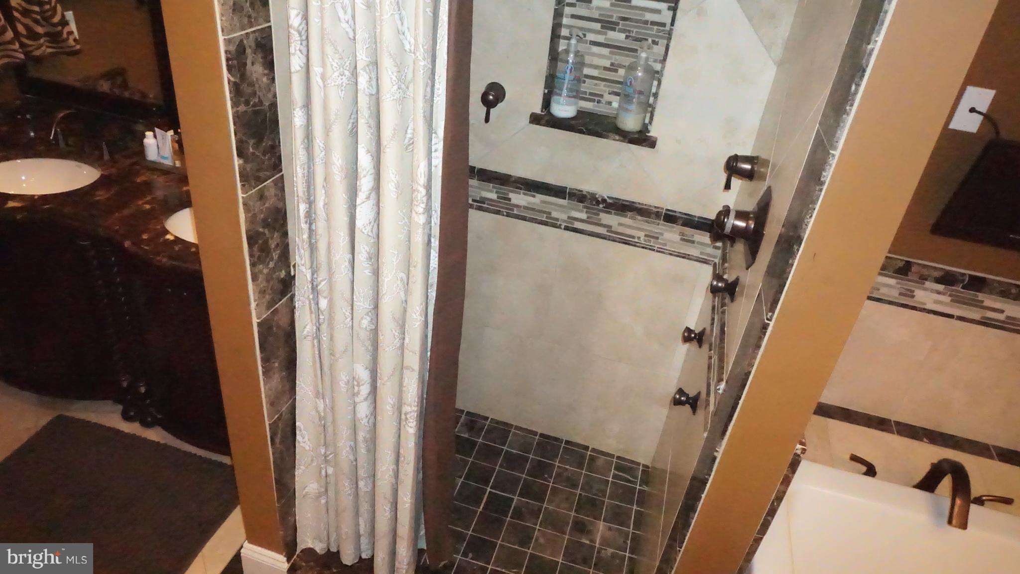 9105 Cuckold Point Road Baltimore, MD 21219 - Photo 25 of 150 a bathroom with a sink and a mirror
