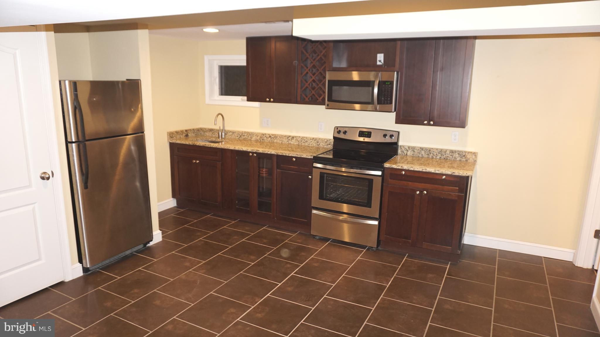 9105 Cuckold Point Road Baltimore, MD 21219 - Photo 36 of 150 a kitchen with stainless steel appliances granite countertop a refrigerator and a sink